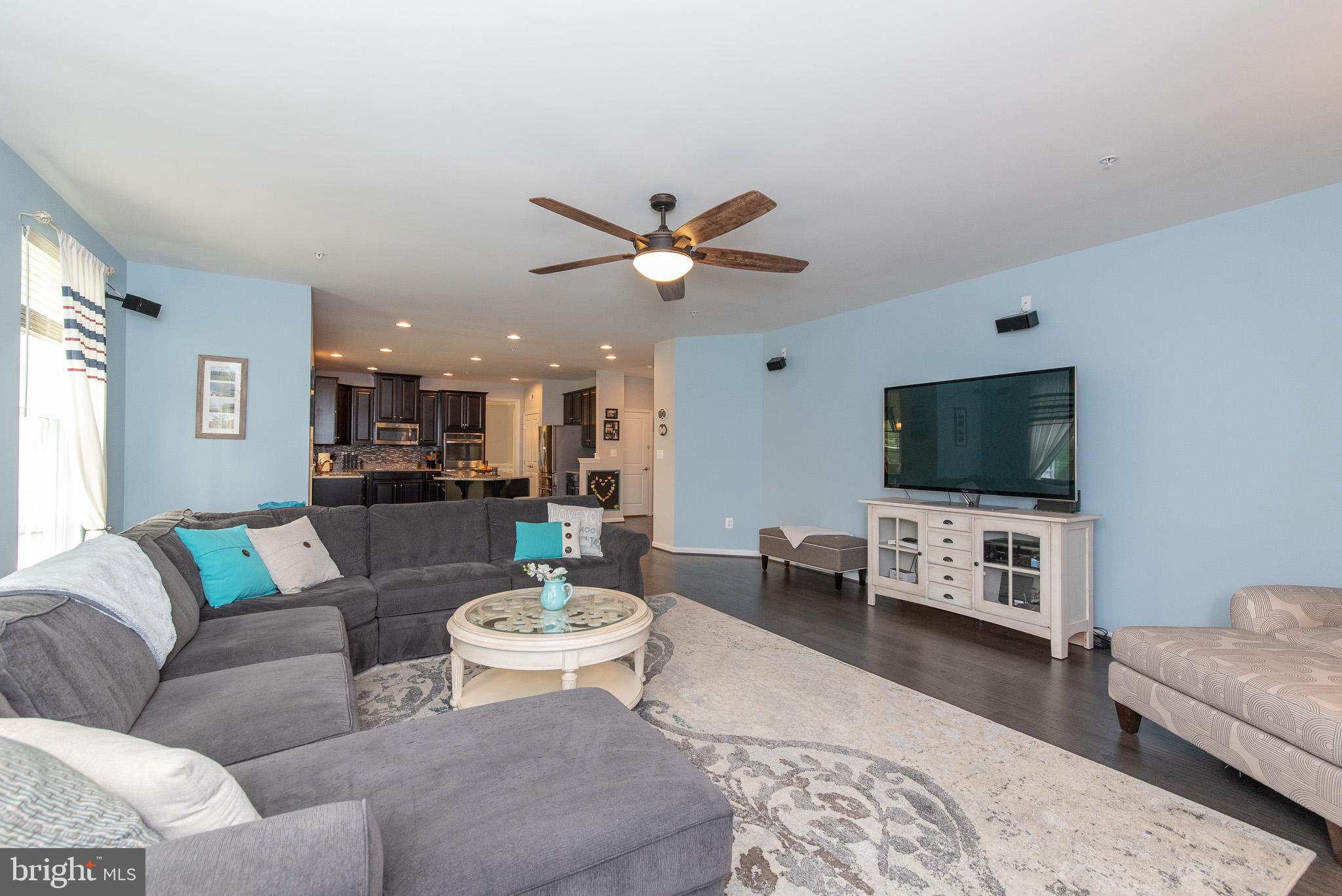 10426 Windlass Run Road Baltimore, MD 21220 - Photo 21 of 56 a living room with furniture and a flat screen tv