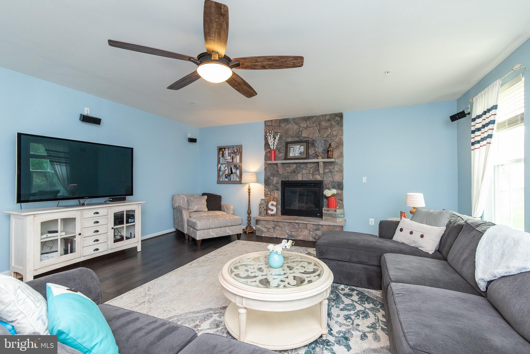 10426 Windlass Run Road Baltimore, MD 21220 - Photo 22 of 56 a living room with furniture a flat screen tv and a fireplace