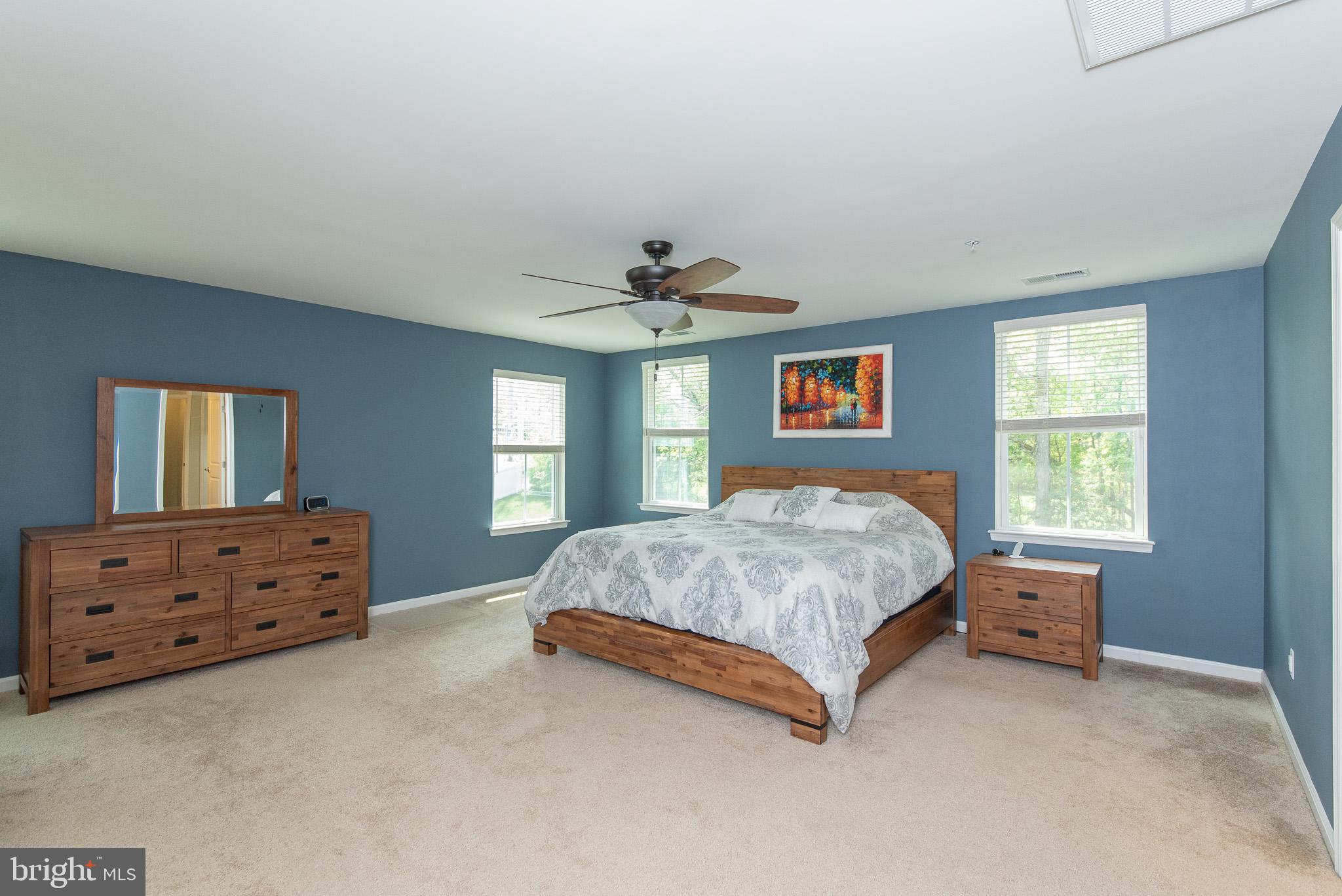 10426 Windlass Run Road Baltimore, MD 21220 - Photo 28 of 56 a bed sitting in a bedroom next to a window and dresser