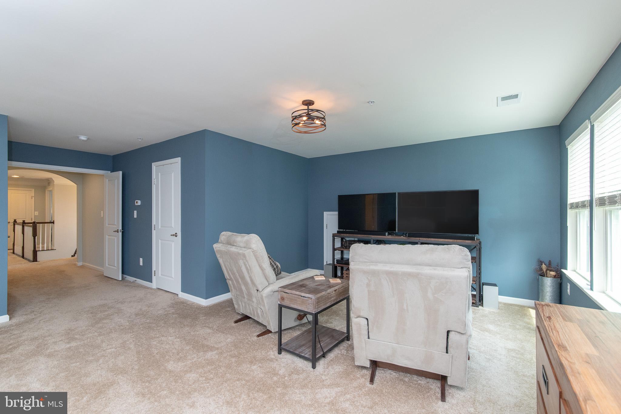 10426 Windlass Run Road Baltimore, MD 21220 - Photo 32 of 56 a view of a livingroom with furniture and a flat screen tv