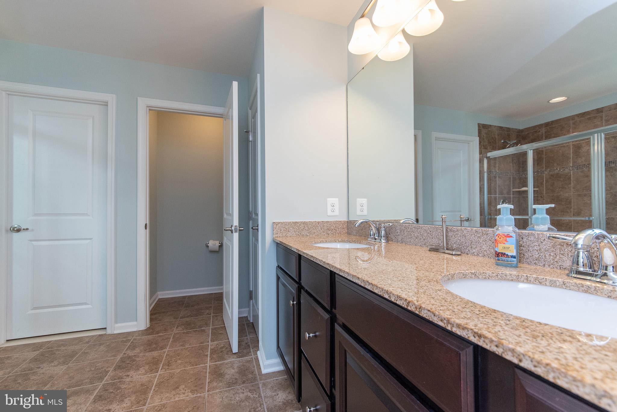 10426 Windlass Run Road Baltimore, MD 21220 - Photo 33 of 56 a bathroom with a granite countertop sink and a mirror