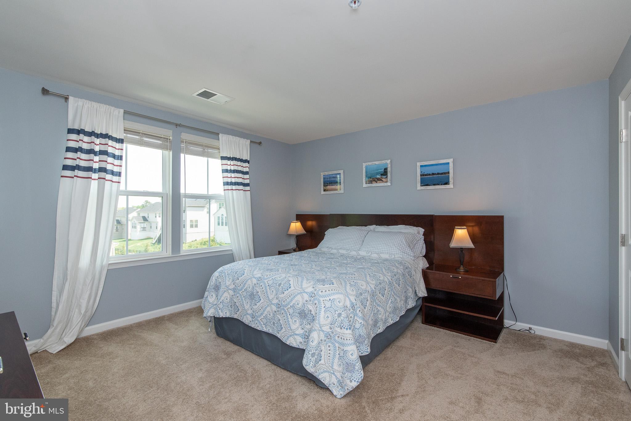 10426 Windlass Run Road Baltimore, MD 21220 - Photo 36 of 56 a spacious bedroom with a bed and a window
