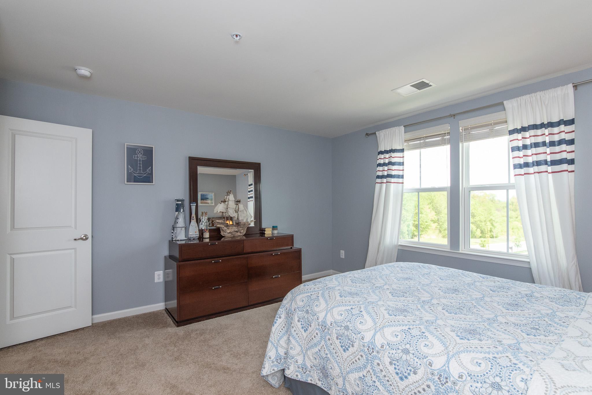 10426 Windlass Run Road Baltimore, MD 21220 - Photo 38 of 56 a bedroom with a bed and a dresser