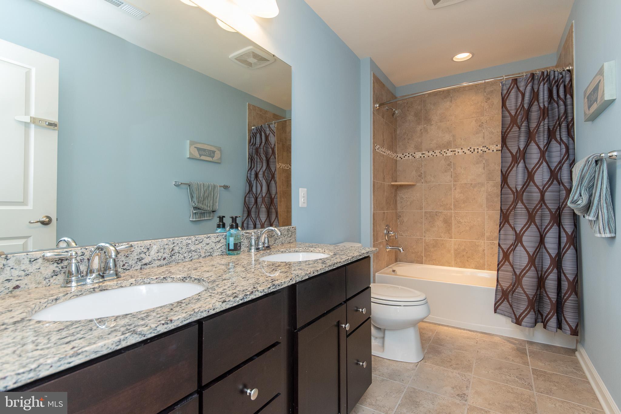 10426 Windlass Run Road Baltimore, MD 21220 - Photo 43 of 56 a bathroom with a granite countertop sink toilet and shower