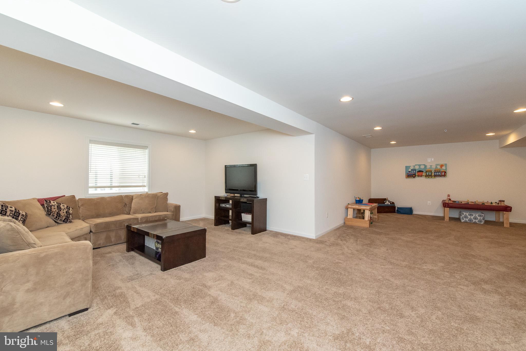 10426 Windlass Run Road Baltimore, MD 21220 - Photo 45 of 56 a living room with furniture and a flat screen tv