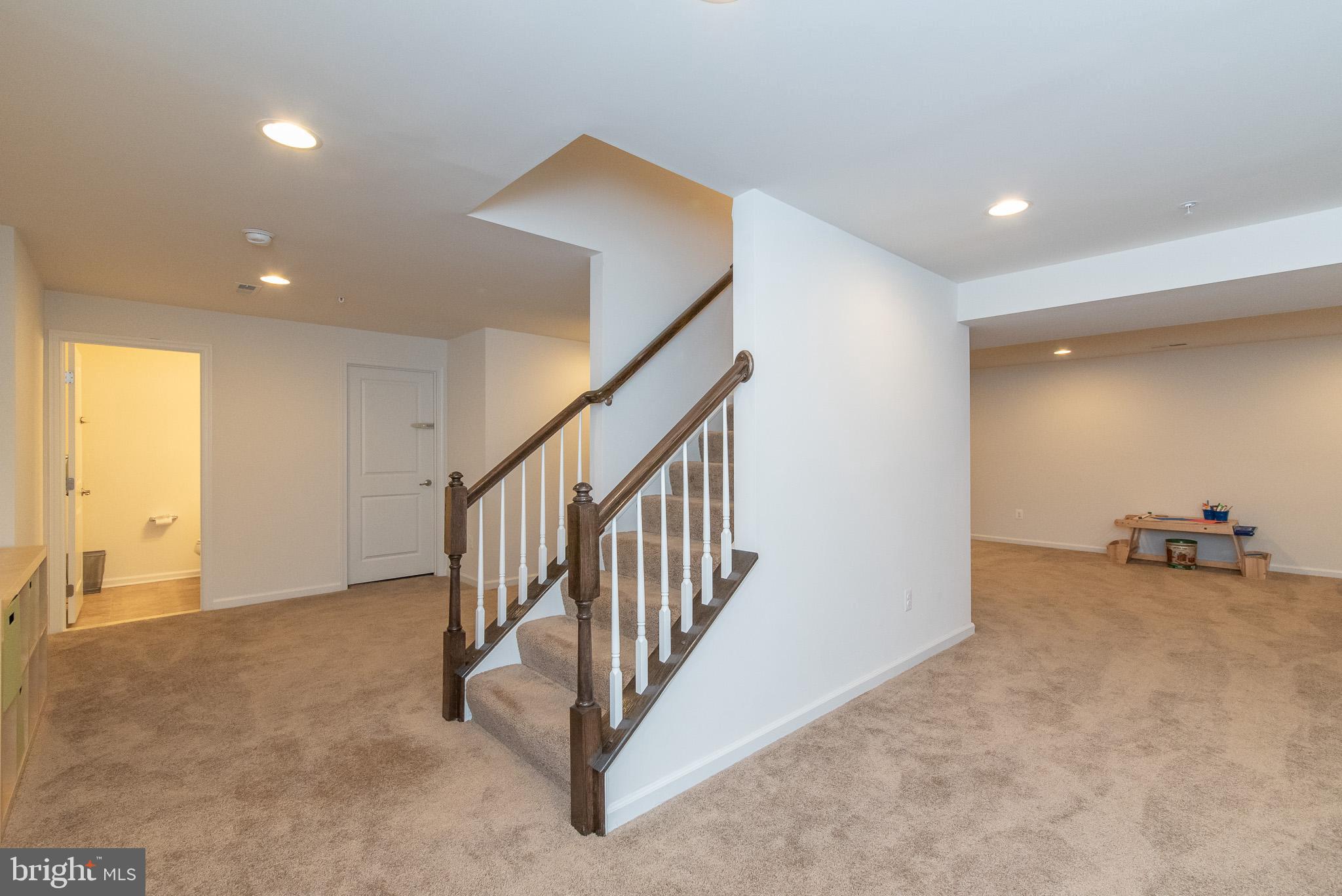 10426 Windlass Run Road Baltimore, MD 21220 - Photo 51 of 56 a view of an empty room with stairs and a living room