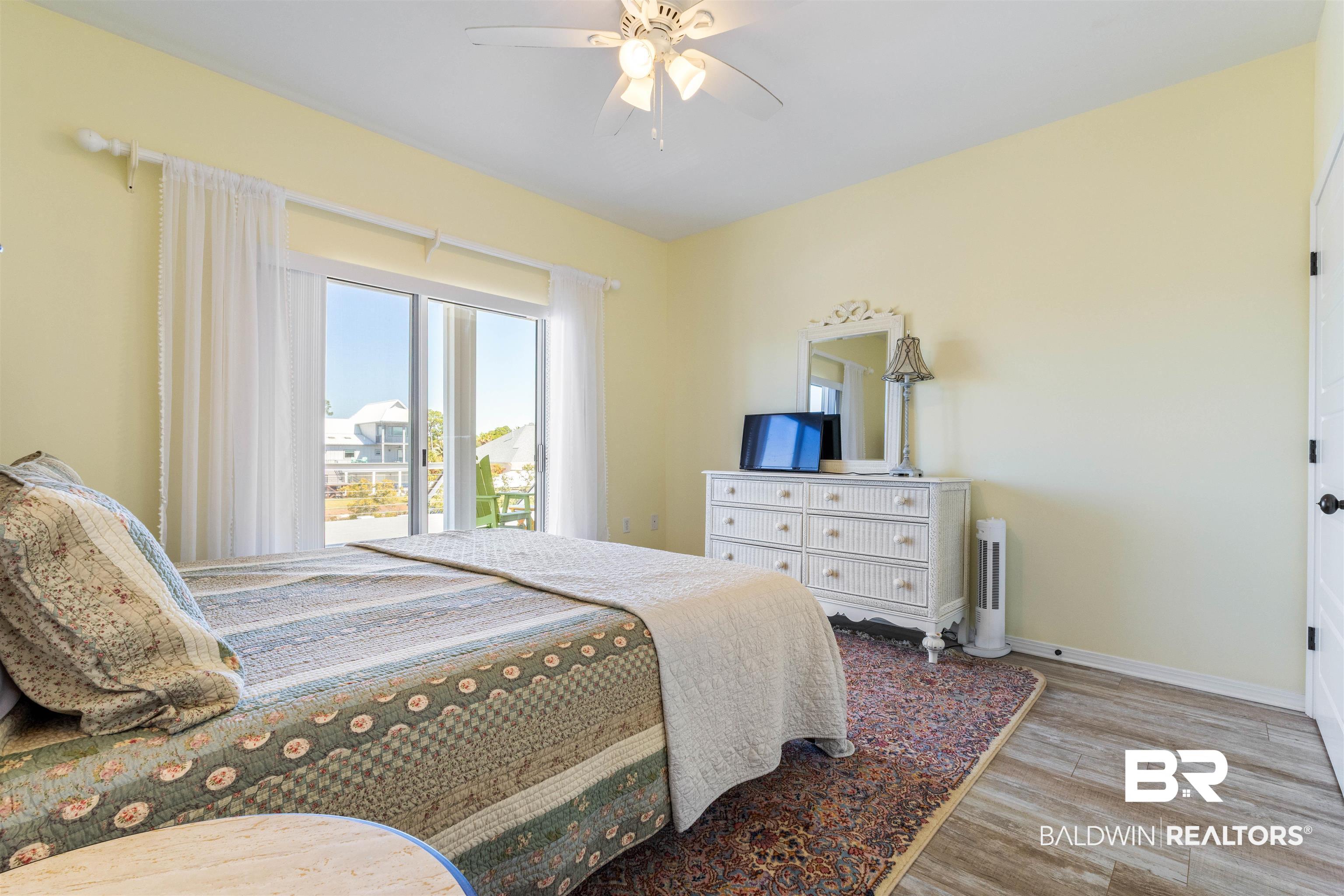 32315 River Road Orange Beach, AL 36561 - Photo 35 of 68 Bedroom with light wood like tile floors, a ceiling fan, and access to outside