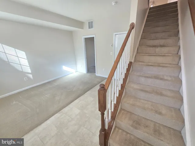 a view of staircase with white walls and windows