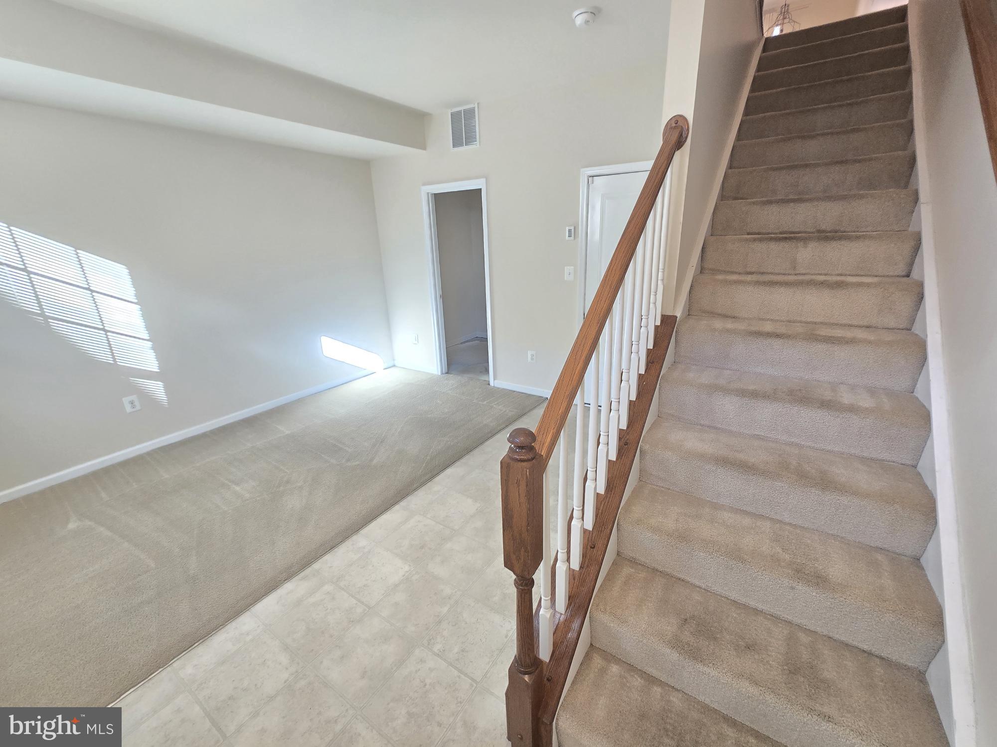 705 South Macon Street Baltimore, MD 21224 - Photo 3 of 29 a view of staircase with white walls and windows