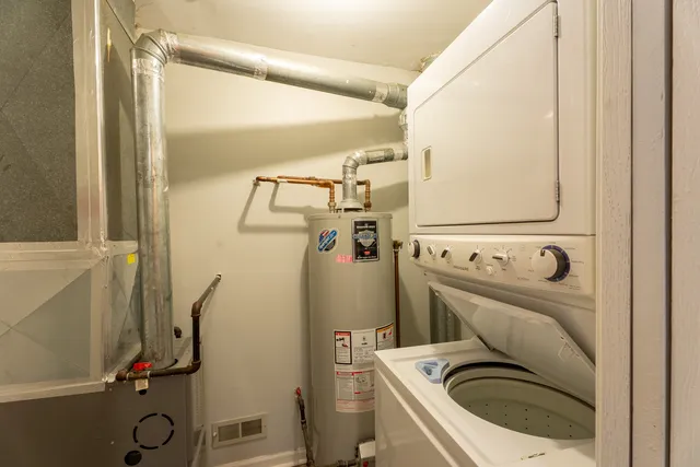 a view of a storage and utility room with a washer dryer