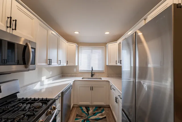 a kitchen with a sink stove and refrigerator