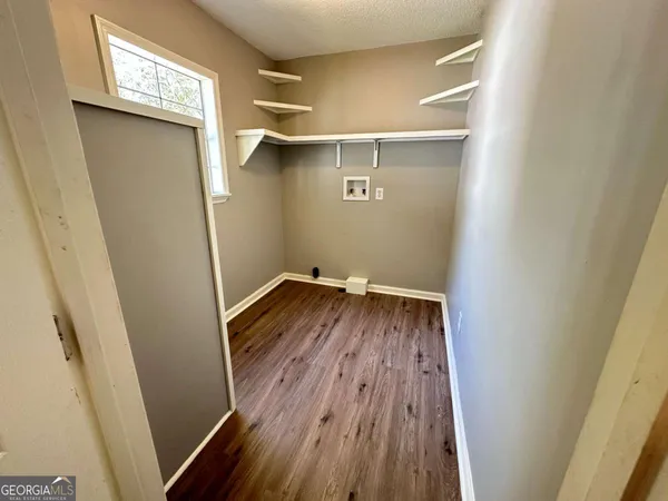 a view of a room with wooden floor and staircase