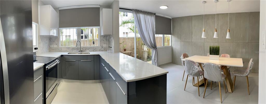 290 Av. Sta. Ana Guaynabo, Bayamón 00969 - Photo 6 of 23 a kitchen with stainless steel appliances kitchen island granite countertop furniture and a refrigerator