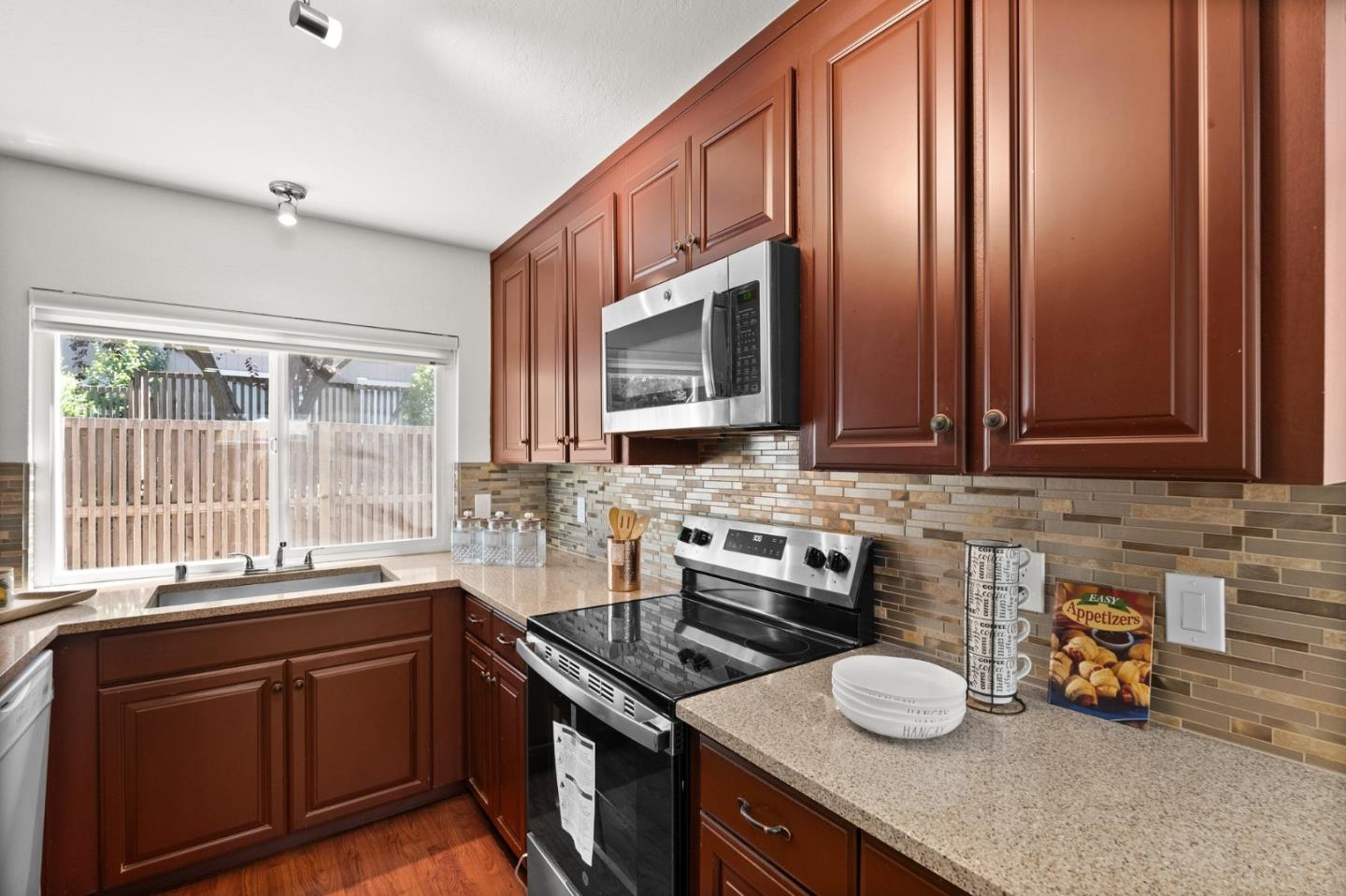 22812 Longdown Road Cupertino, CA 95014 - Photo 13 of 45 a kitchen with a sink a stove and cabinets