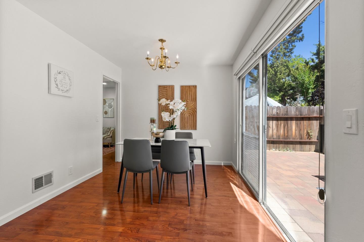 22812 Longdown Road Cupertino, CA 95014 - Photo 17 of 45 a view of a dining room with furniture and wooden floor
