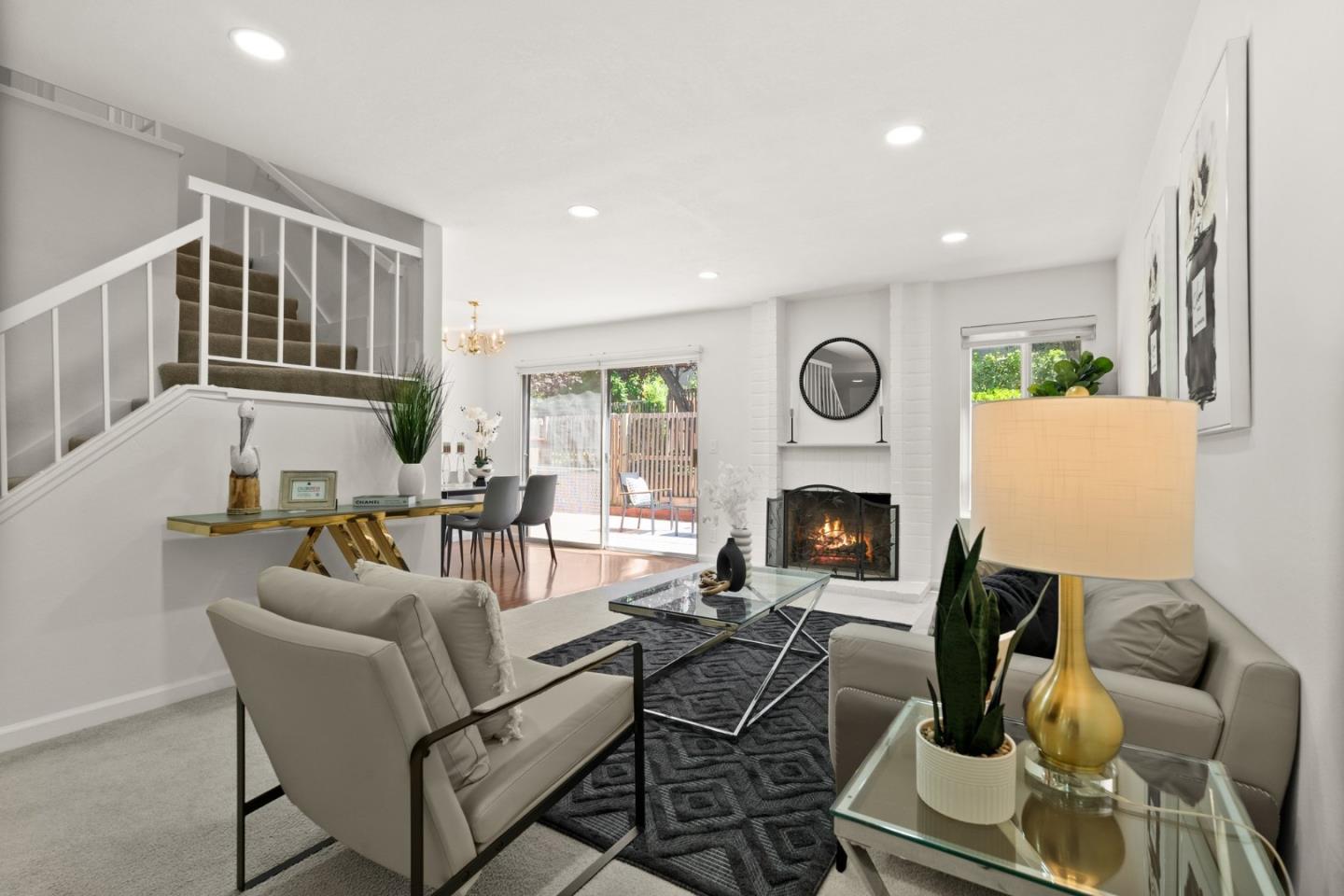 22812 Longdown Road Cupertino, CA 95014 - Photo 20 of 45 a living room with furniture a fireplace and a open kitchen view