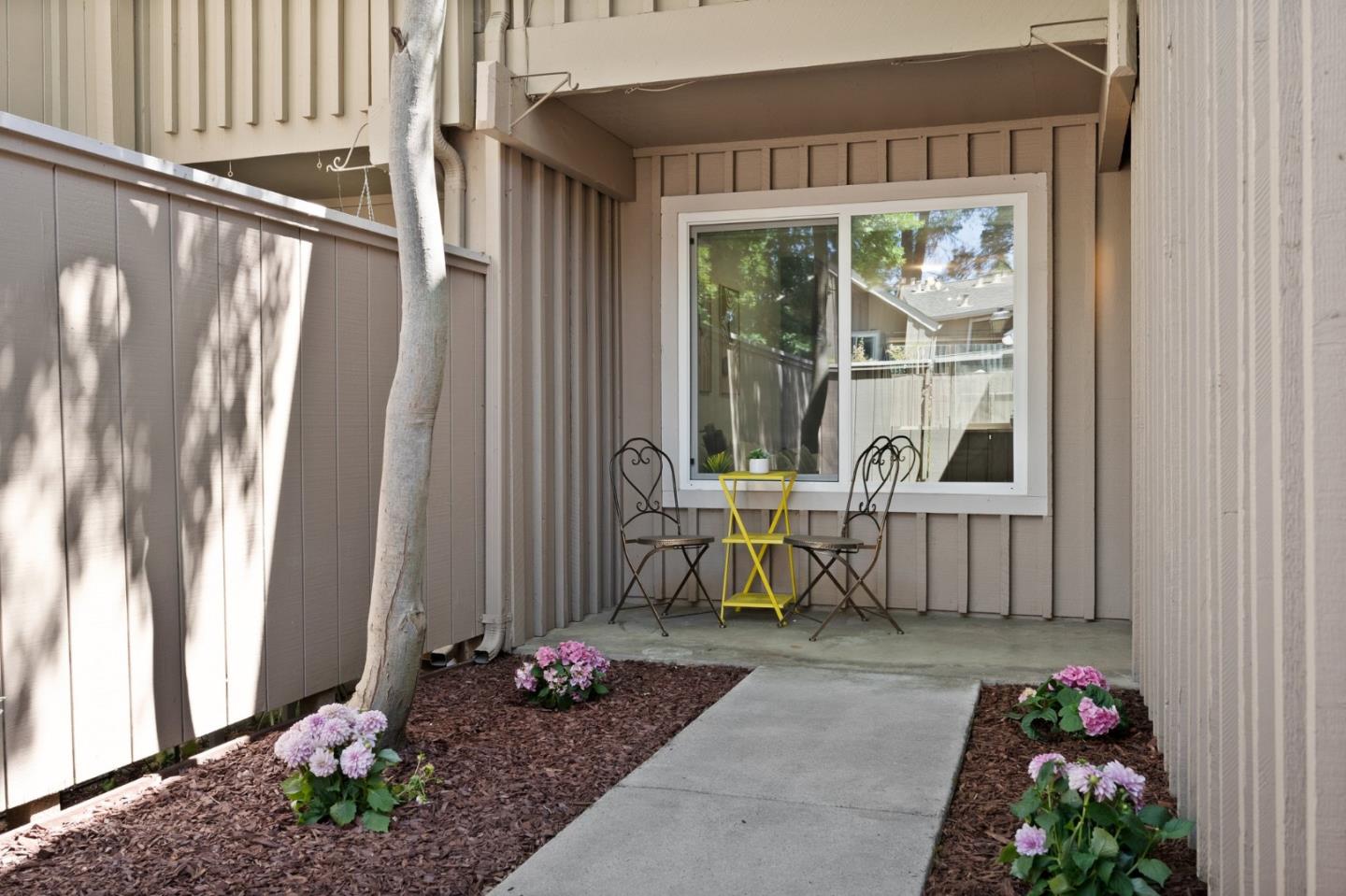 22812 Longdown Road Cupertino, CA 95014 - Photo 4 of 45 a living room with a outdoor dining table and a chairs