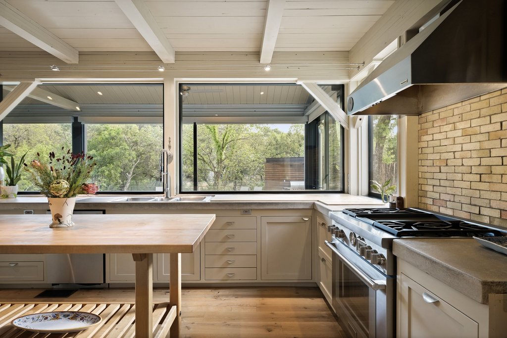 4707 Peace Pipe Path Austin, TX 78746 - Photo 14 of 40 a kitchen with a stove and a sink