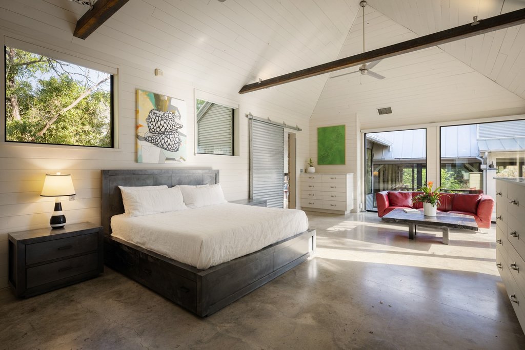 4707 Peace Pipe Path Austin, TX 78746 - Photo 20 of 40 a spacious bedroom with a bed and a large window