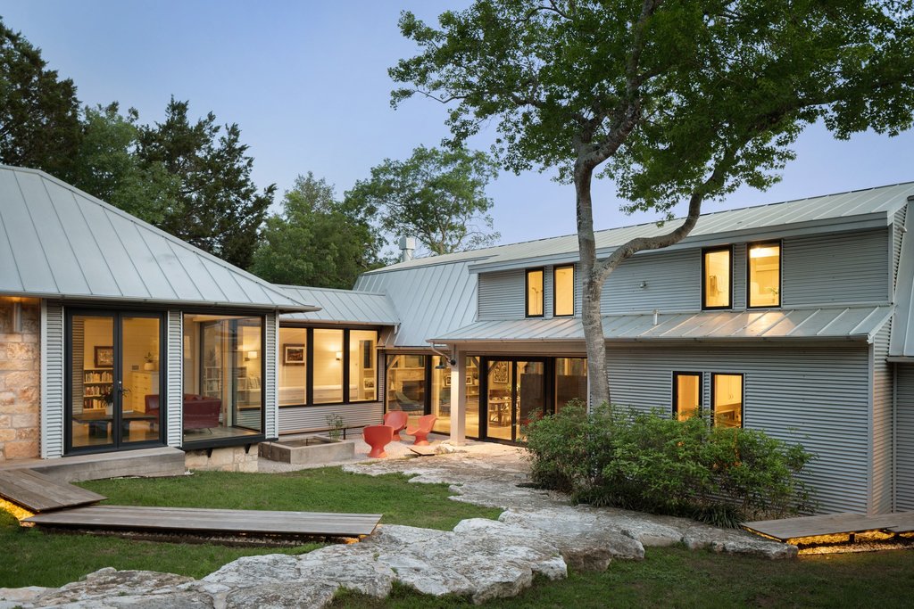 4707 Peace Pipe Path Austin, TX 78746 - Photo 4 of 40 a front view of a house with a yard table and chairs