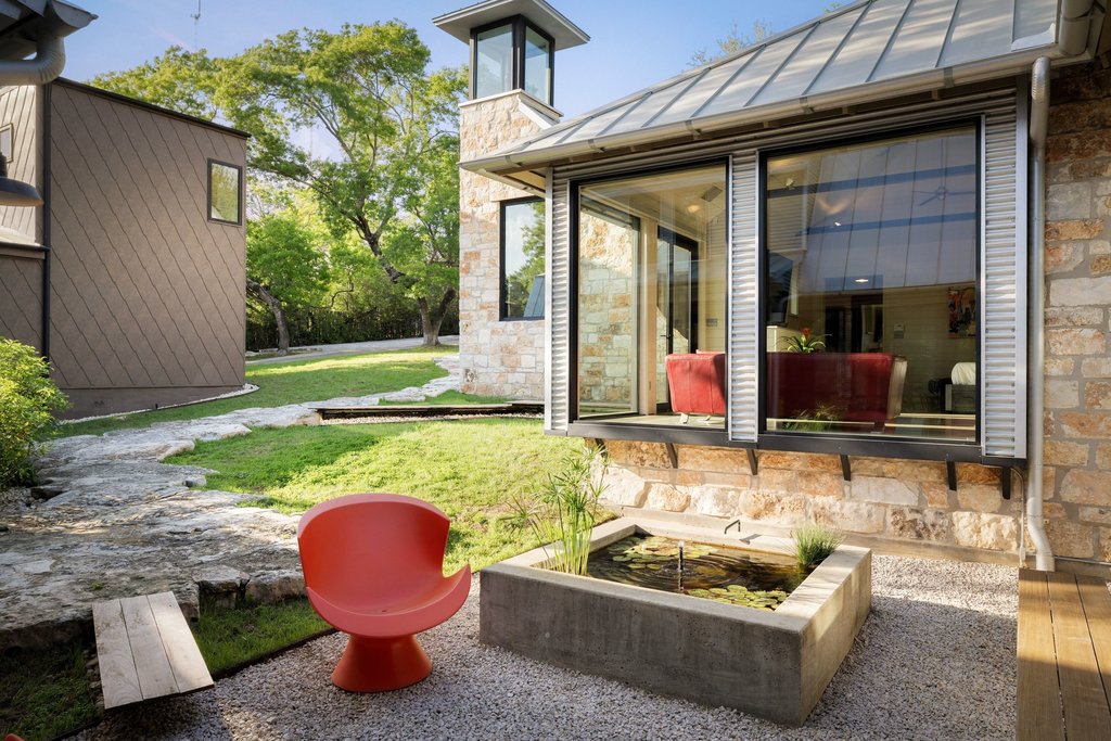 4707 Peace Pipe Path Austin, TX 78746 - Photo 5 of 40 a view of an outdoor sitting area with furniture and garden