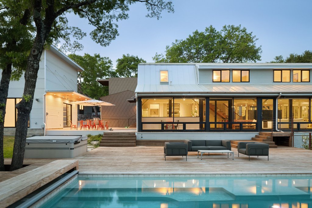 4707 Peace Pipe Path Austin, TX 78746 - Photo 7 of 40 a front view of a house with lots of trees and plants