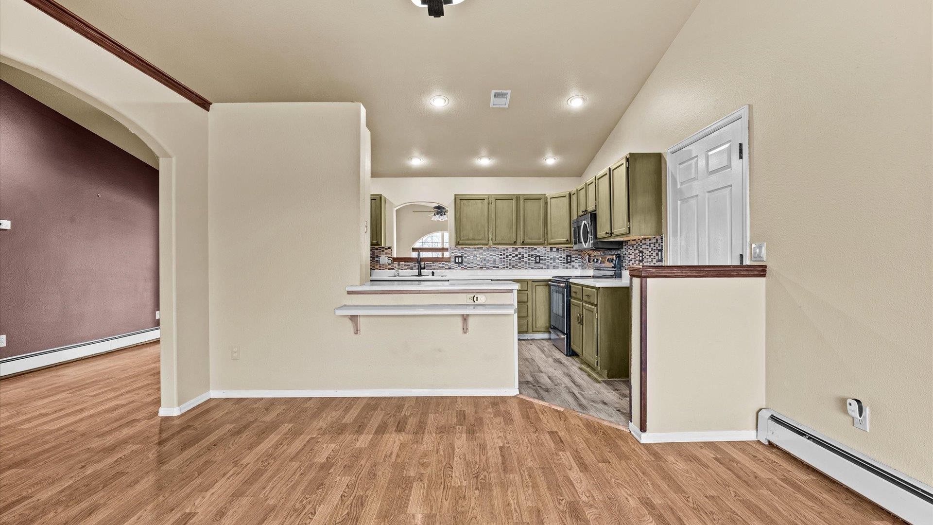1195-17 1/2 North 1/2 Road Fruita, CO 81521 - Photo 13 of 33 a kitchen with a refrigerator and white cabinets