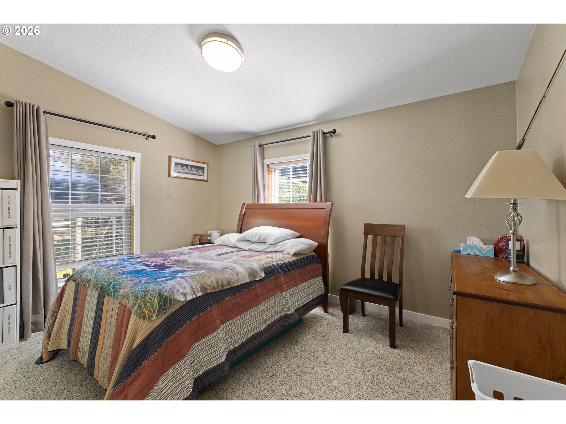 69323 Wildwood Road North Bend, OR 97459 - Photo 21 of 37 a bedroom with a bed and a lamp on table
