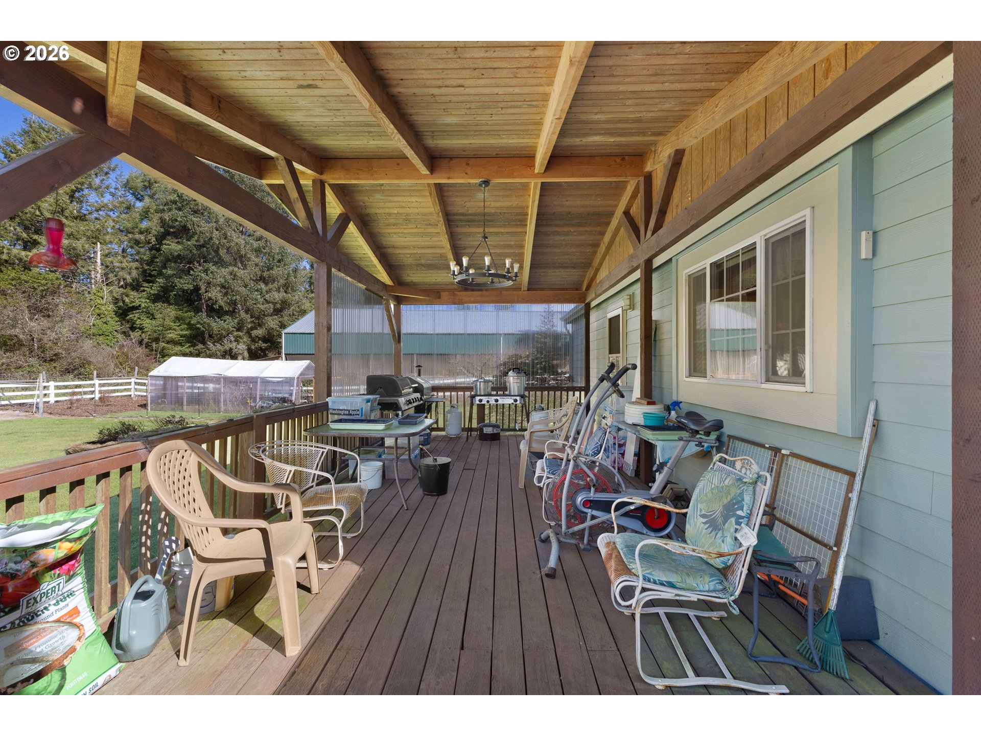 69323 Wildwood Road North Bend, OR 97459 - Photo 24 of 37 a view of a patio with table and chairs and potted plants