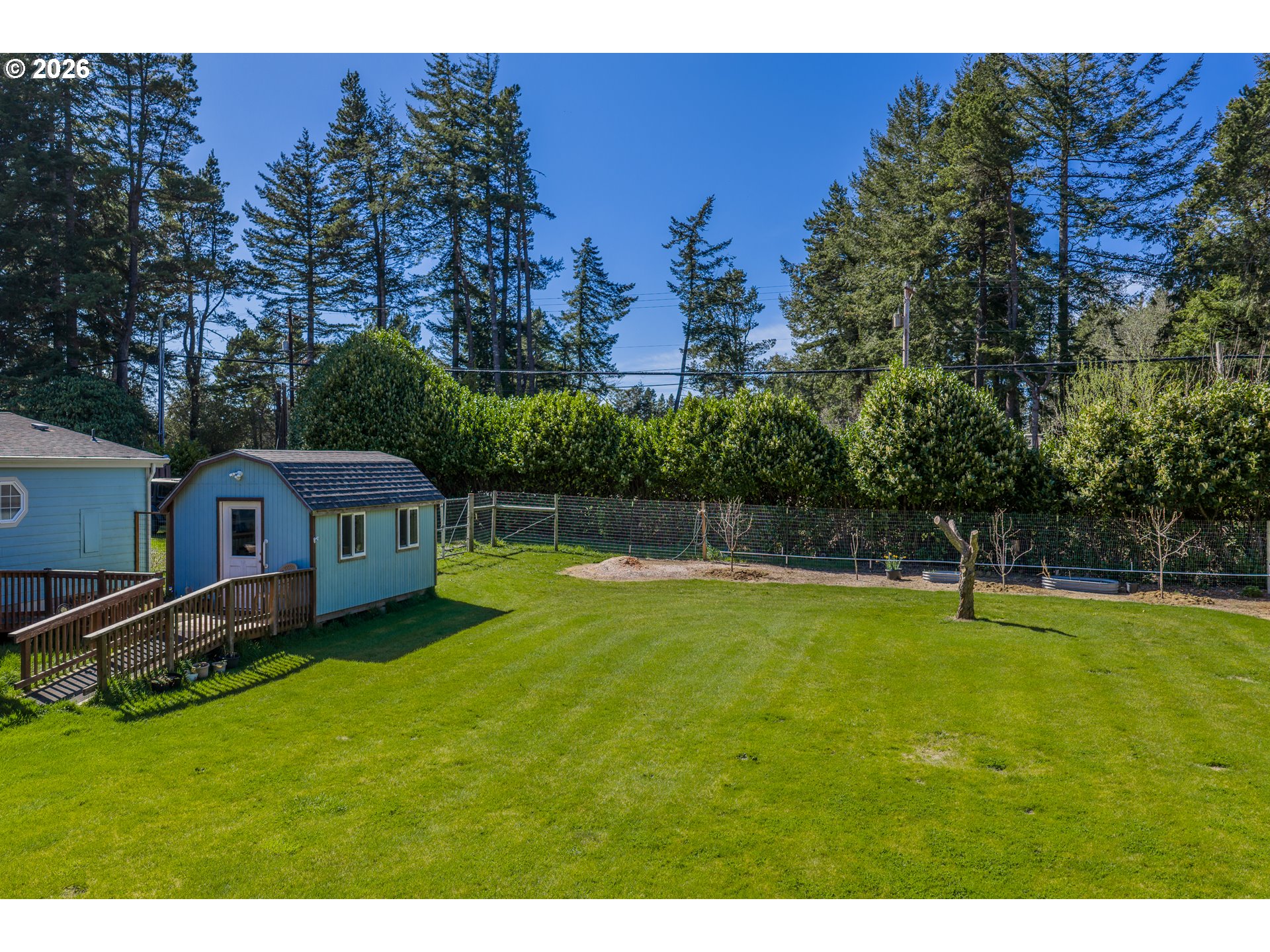 69323 Wildwood Road North Bend, OR 97459 - Photo 28 of 37 a view of a house with a backyard