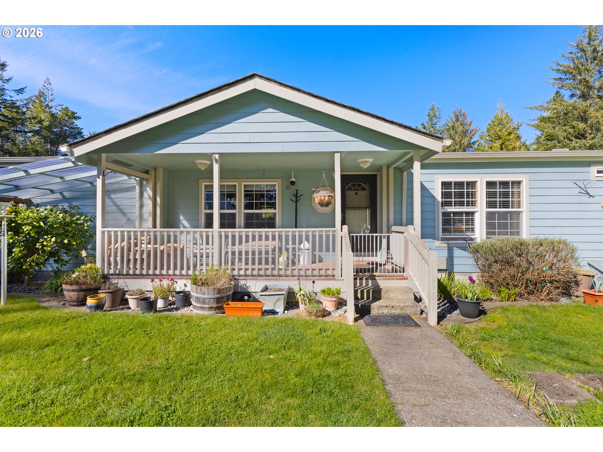 69323 Wildwood Road North Bend, OR 97459 - Photo 3 of 37 a front view of a house with a yard