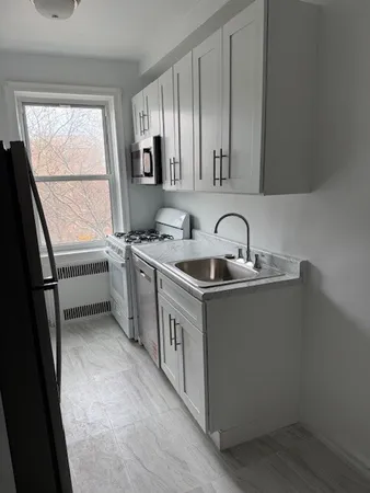 a kitchen with a sink stove and cabinets