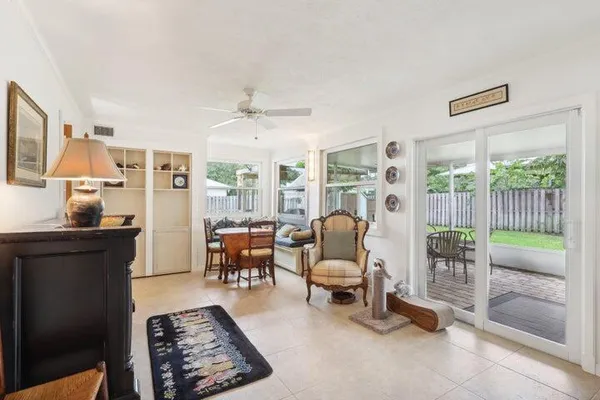 a living room with furniture and a floor to ceiling window