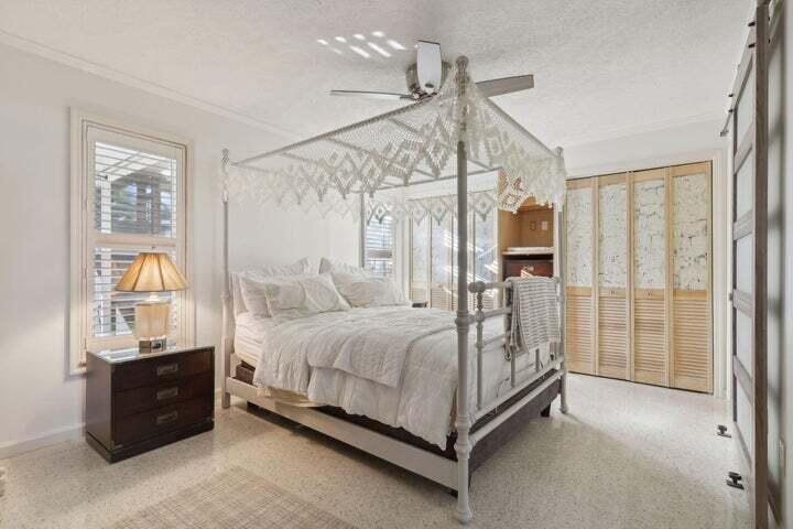 4844 Southeast Pilot Way Stuart, FL 34997 - Photo 15 of 44 a bedroom with a bed and a chandelier