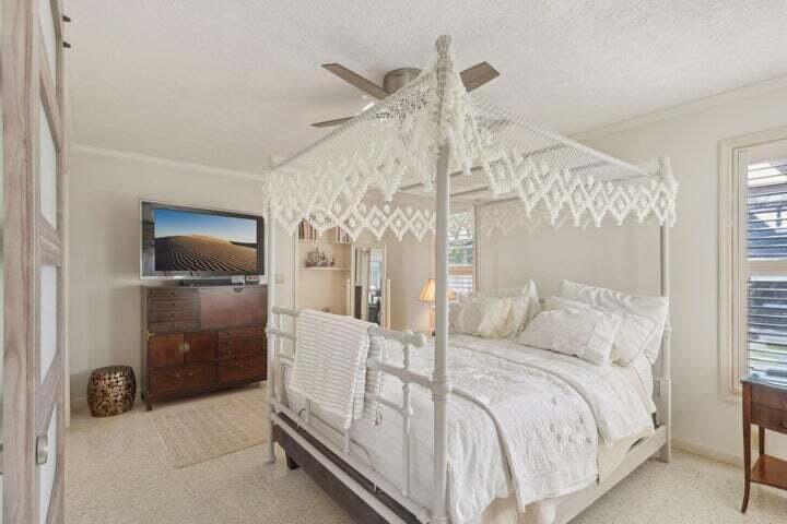 4844 Southeast Pilot Way Stuart, FL 34997 - Photo 17 of 44 a bedroom with a bed and a flat tv screen on the dresser