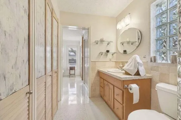 a bathroom with a toilet a sink and a mirror