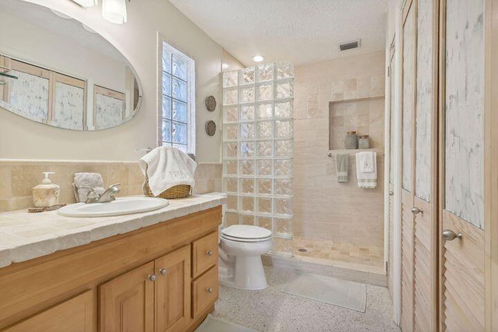 4844 Southeast Pilot Way Stuart, FL 34997 - Photo 19 of 44 a bathroom with a sink a toilet and shower