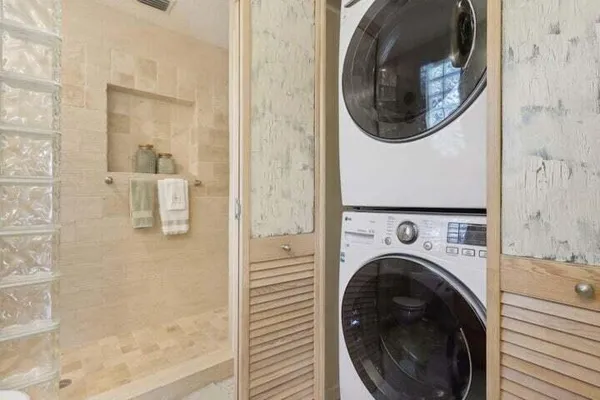 a view of a hallway with washer and dryer