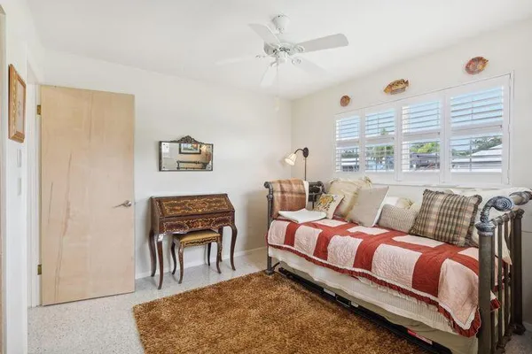 a bedroom with furniture and a window