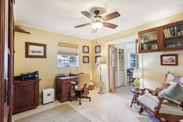 a view of a livingroom with workspace and a window