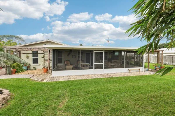 a view of a house with a yard and sitting area