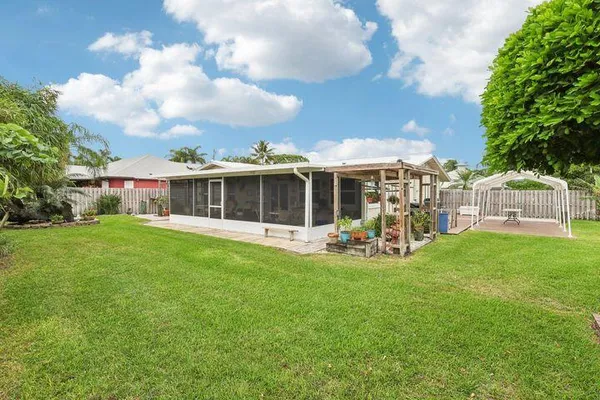 a view of a house with backyard porch and sitting area