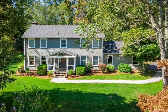 a front view of a house with a yard table and chairs