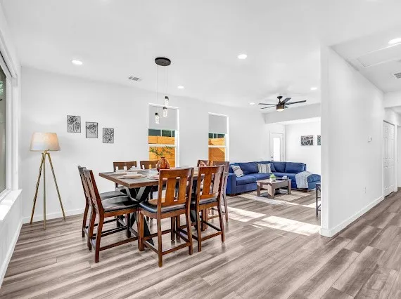 a view of a dining room with furniture and wooden floor