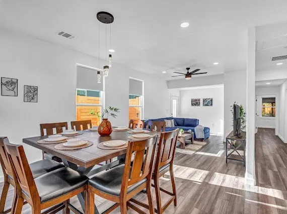 a view of a dining room with furniture window and wooden floor
