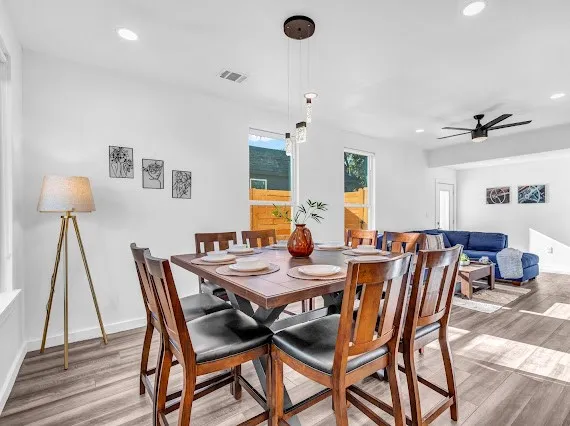 a view of a dining room with furniture and wooden floor