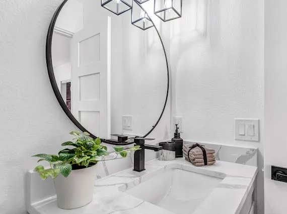 a bathroom with a sink a mirror and a mirror