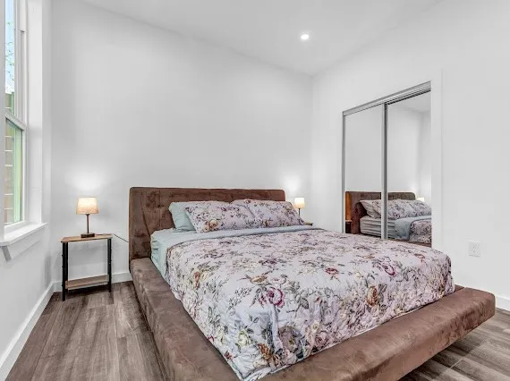 a bedroom with a bed and window
