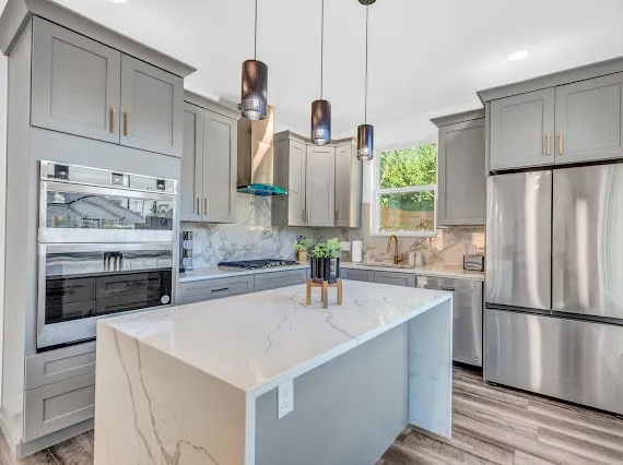 a kitchen with stainless steel appliances a sink and a refrigerator