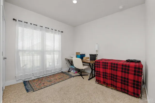 a bedroom with furniture and a window